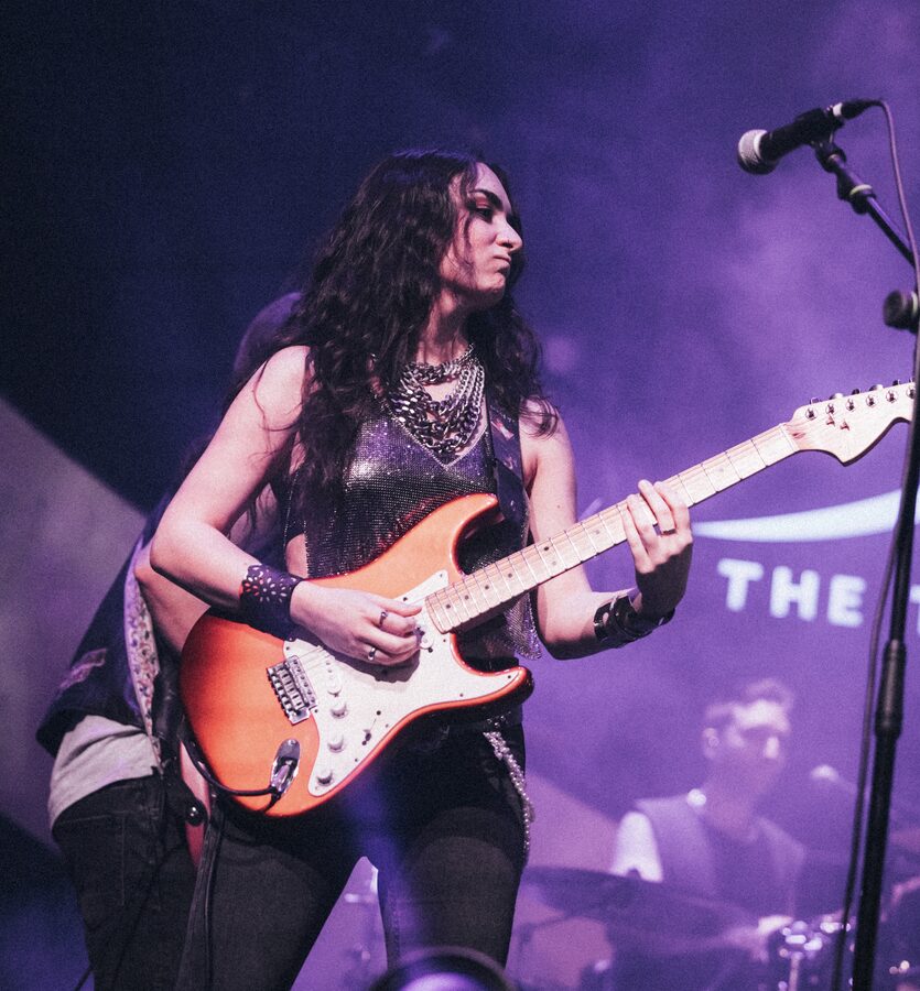 Lead guitar mid-solo under the stage lights